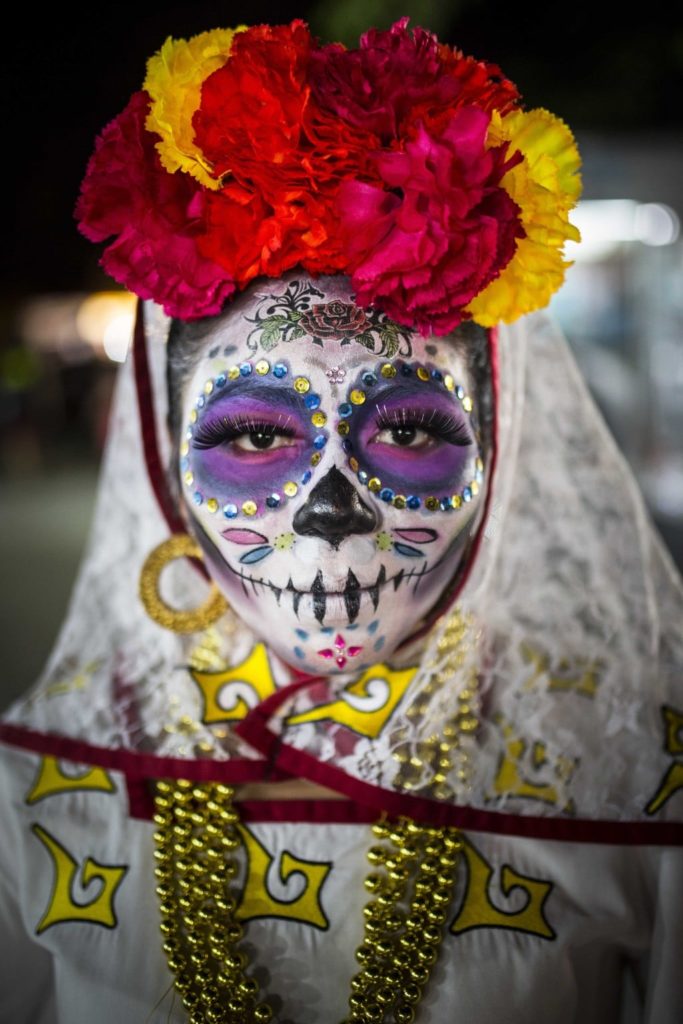 2 November 2016 - The portrait of a woman dressed in skull-candy face paint and costume to celebrate the Day of the Dead festival in Cancun’s El Parque De Las Palapas, Mexico. The festival, locally known as ‘Dia De Los Muertos’ is an annual celebration in memory of loved ones who have passed away. Seeing the festival has been on my bucket-list for years, so when my trip to Mexico coincided with the celebrations I asked some locals where best to witness it. I spotted this woman just before leaving the festival, after all the parades and dancing had finished. Her eyes were so enchanting and her make-up pristine, I couldn’t resist stopping her and asking for a photograph. I find her solemn expression juxtaposed with her colourful make up and accessories striking, and a nice portrayal of how the event celebrates what is usually considered a sad time.